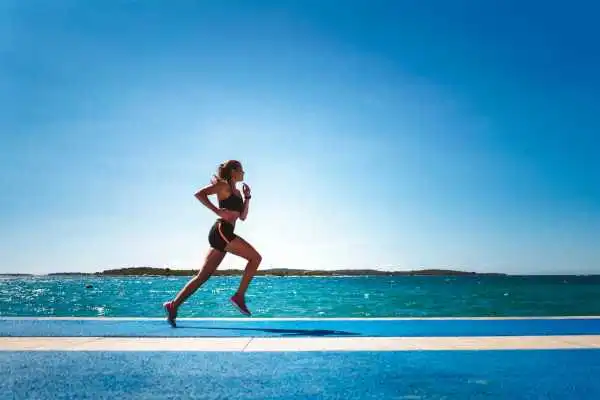 Woman running showing strong leg muscle Sunningdale